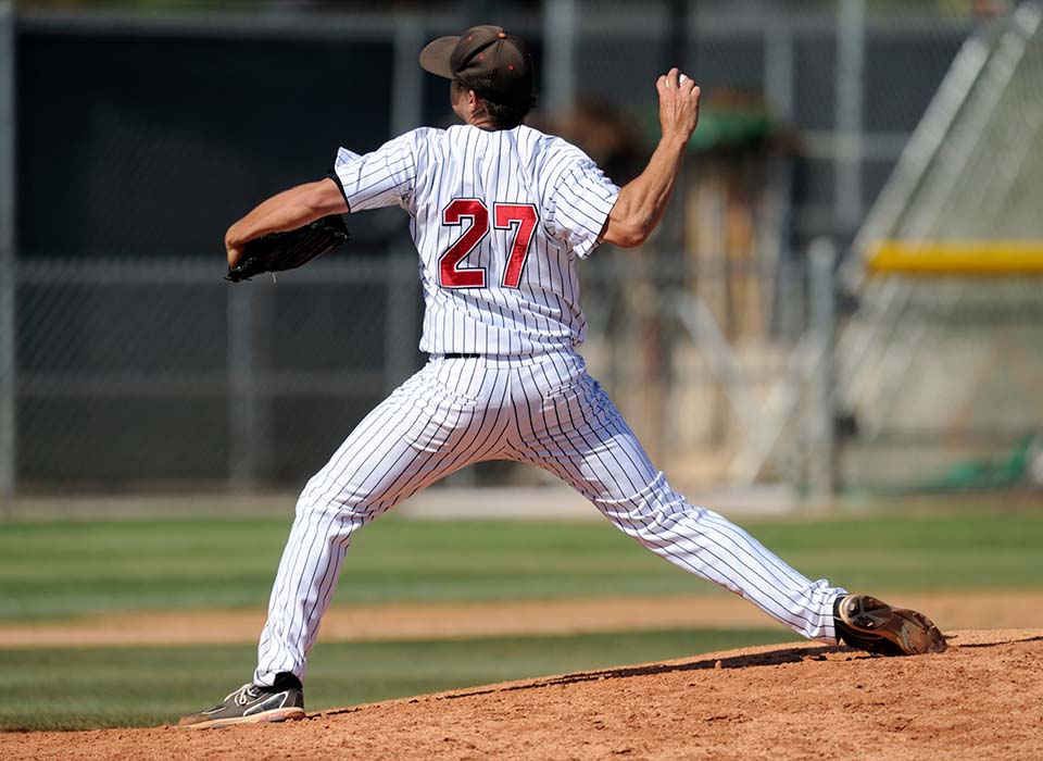 man pitching baseball