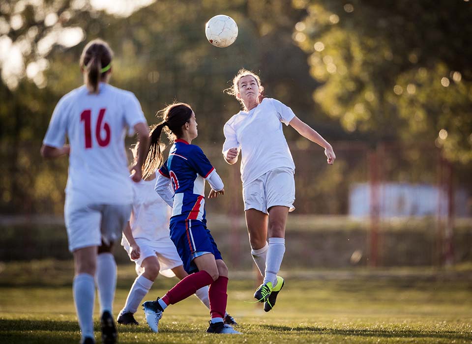 teen girls playing soccer