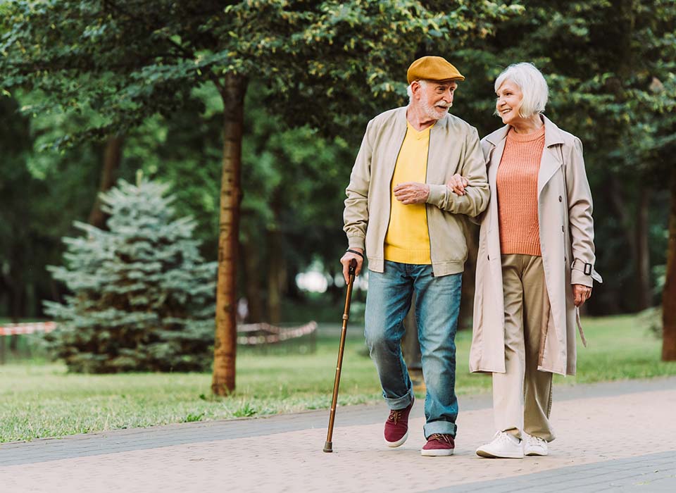 older couple walk outside