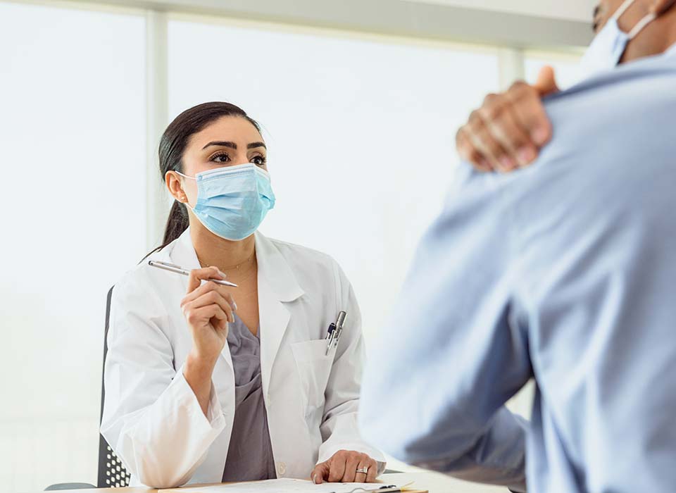 female doctor talking to patient