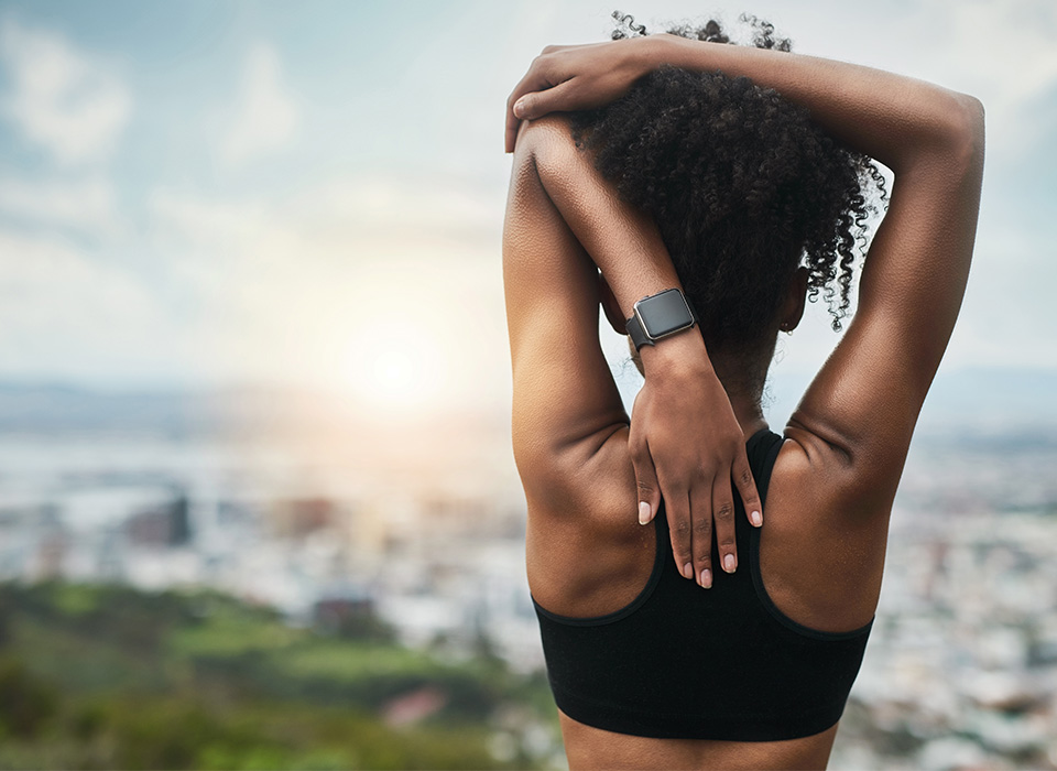 woman stretching her arms outdoors