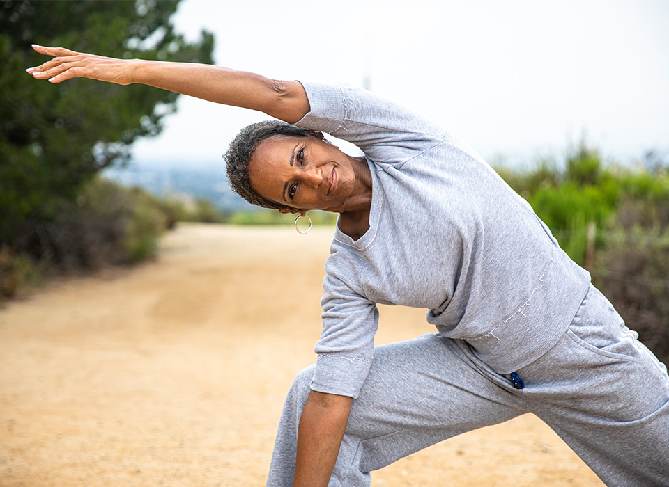 woman in athletic clothes stretching outside
