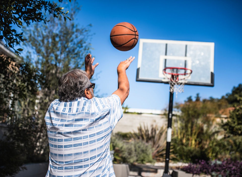 man shooting a basketball at a hoop