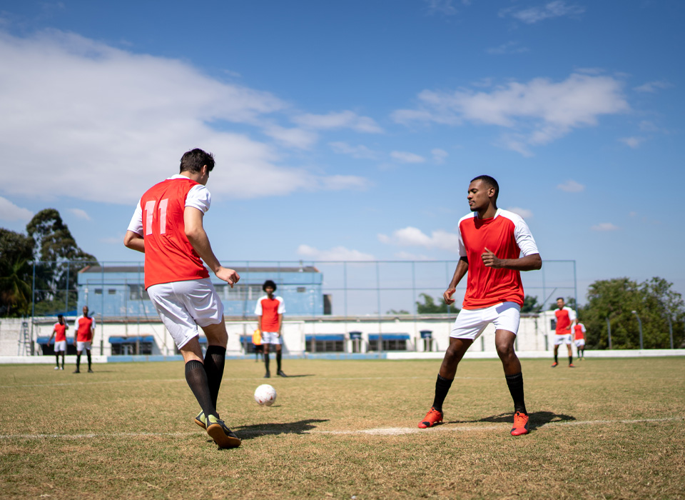 soccer players kicking the ball on the field