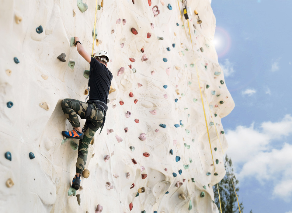 a man on a climbing wall outside
