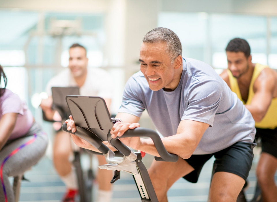 a group of people on spin bikes at a gym