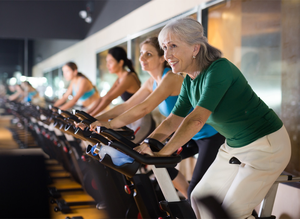 a group of people on spin bikes at a gym