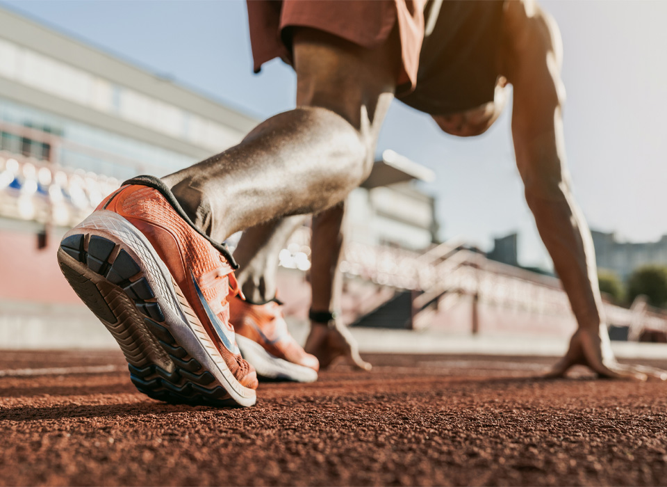 close up of the back foot of a man standing in a race starting position
