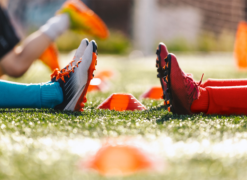 two pairs of feet in soccer cleats