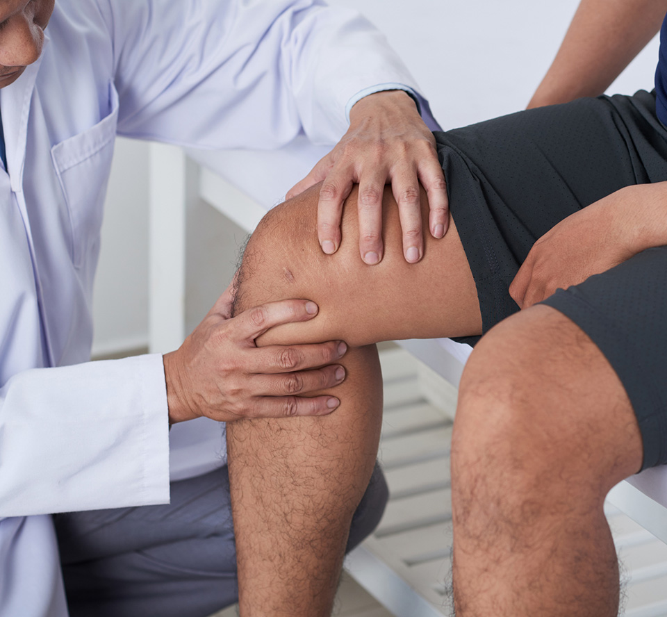 doctor examining patient's knee