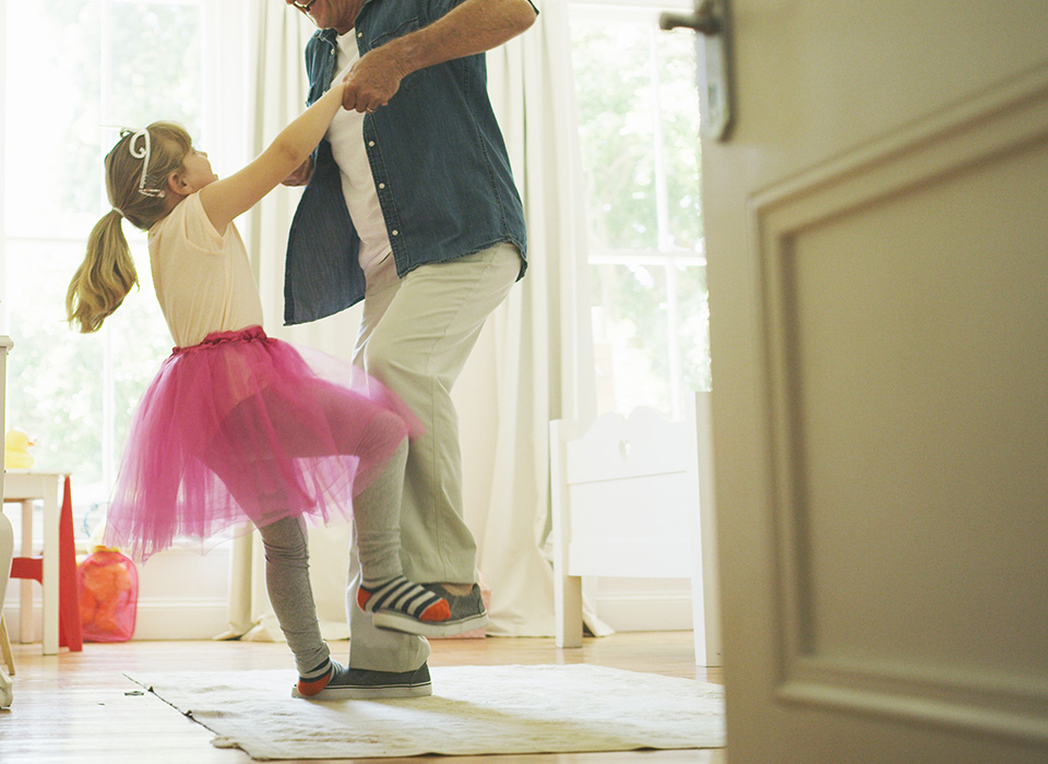 grandfather dancing with young granddaughter